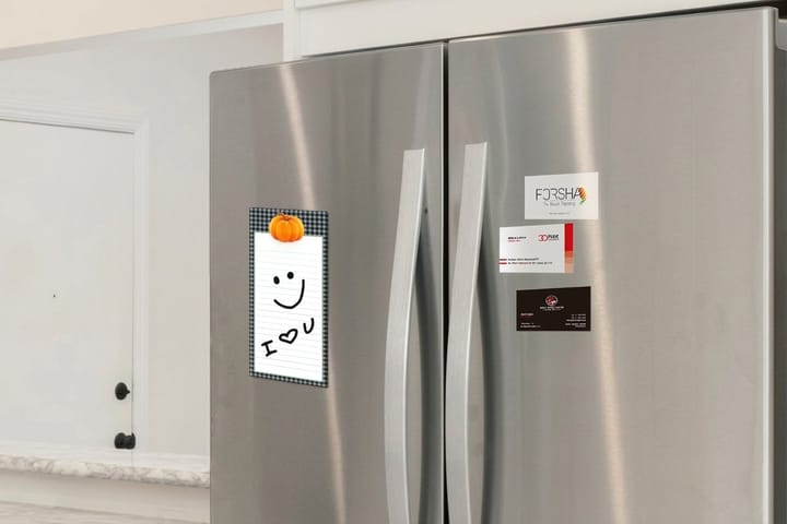 Business card magnets printed by 4OVER4 with car wash hours on a refrigerator