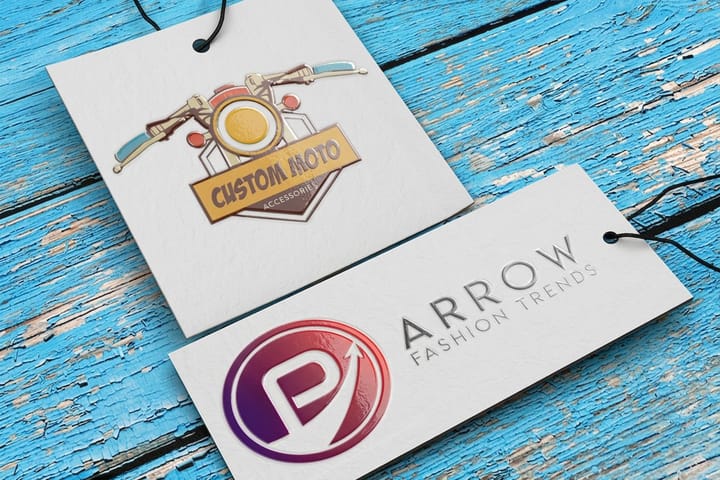 Raised spot UV hangtags printed by 4OVER4 hanging from apparel with glossy raised branding