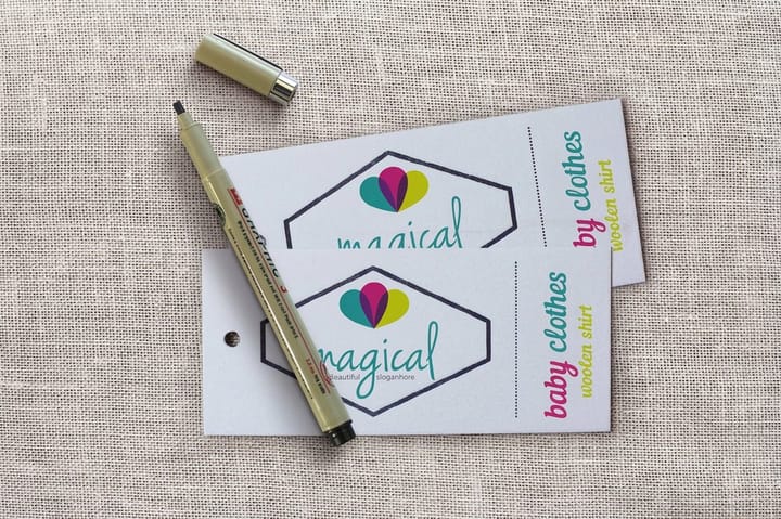 Matte silk laminated hangtags from 4OVER4 attached to folded garments