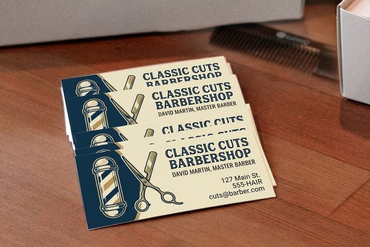 Barber business cards printed by 4OVER4 stacked at a shop counter