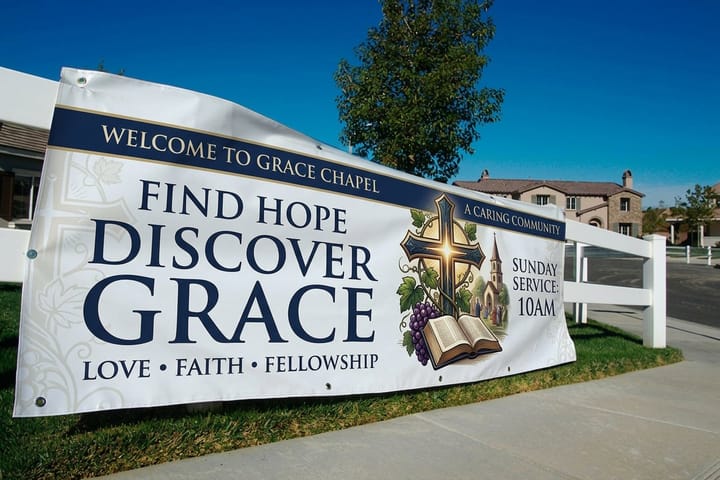 Church banner printed by 4OVER4 announcing a service above an entrance