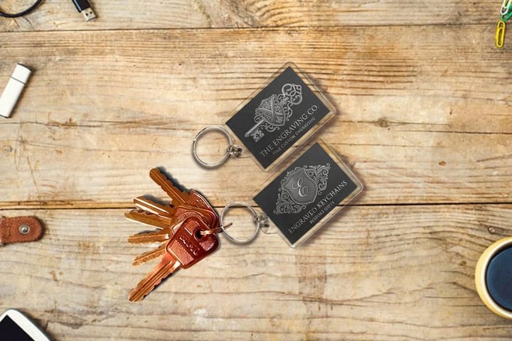 Engraved keychains printed by 4OVER4 in a wood accent finish on a ring