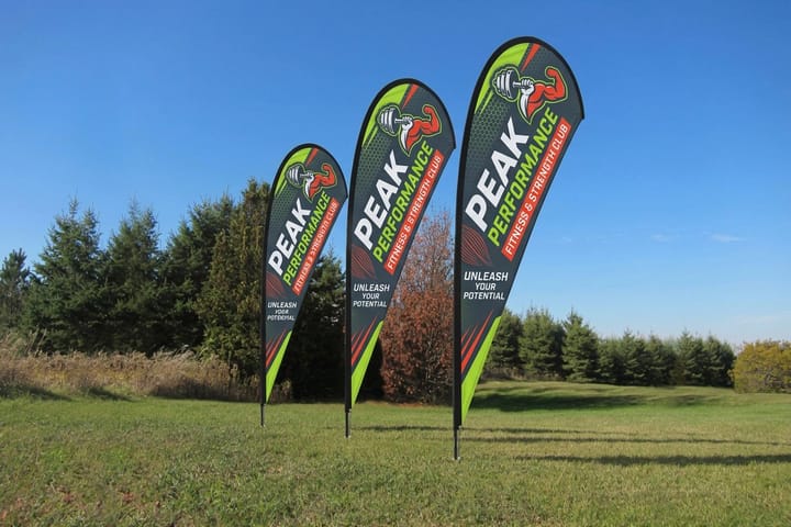 Fitness feather flags printed by 4OVER4 outside a gym entrance