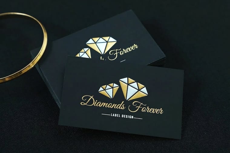 Foil business card tagline that catches the light, printed by 4OVER4