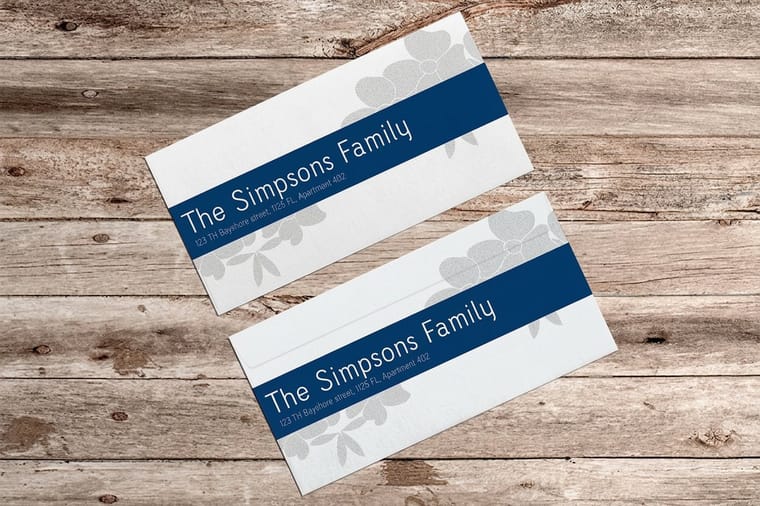 Invitation envelopes printed by 4OVER4 in a neat stack ready for addressing