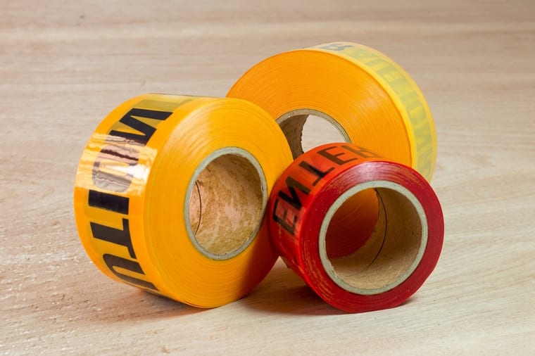 Printed barricade tape strung across a restricted area, printed by 4OVER4