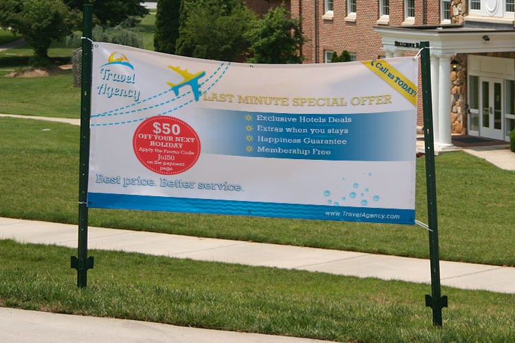 Eye-catching trade show booth with a tall branded display, printed by 4OVER4