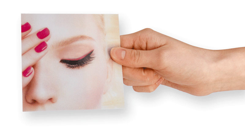 Hand tilting a 3D lenticular card to flip between its two printed artworks
