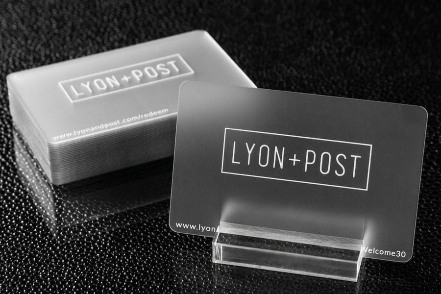 A frosted plastic card from 4OVER4 with a smooth, laminated finish