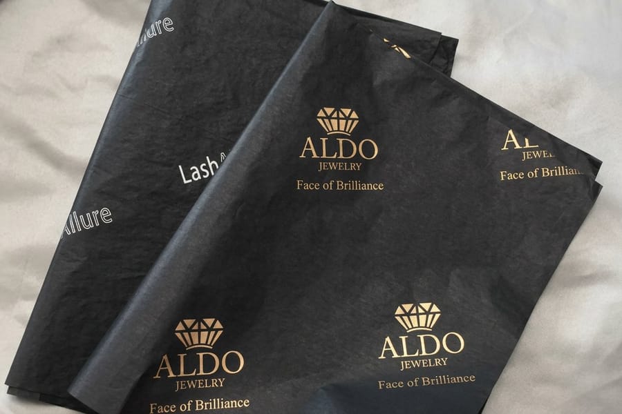 Repeating logo pattern printed across food wrapping paper by 4OVER4