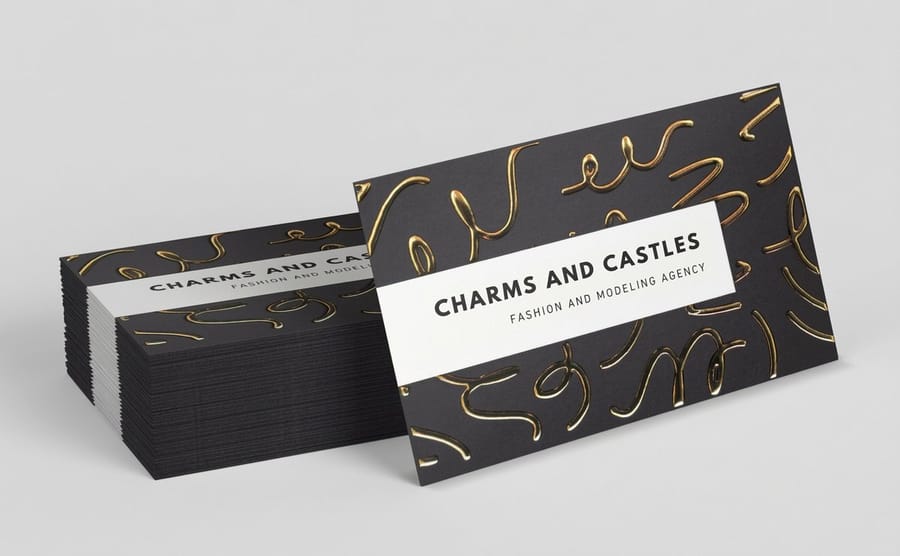 Foil business cards from 4OVER4.COM with a metallic logo pressed into silk stock