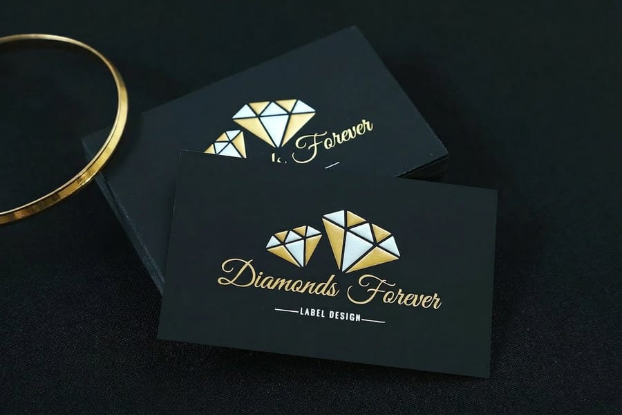 Foil business card tagline that catches the light, printed by 4OVER4