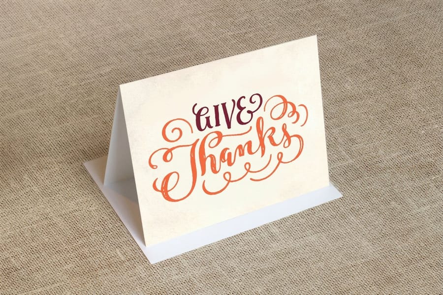 Folded thank-you card open to a handwritten greeting, printed by 4OVER4
