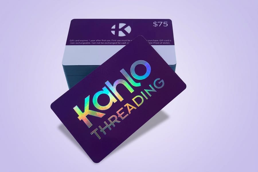 Holographic plastic cards printed by 4OVER4 with an iridescent surface across the whole card