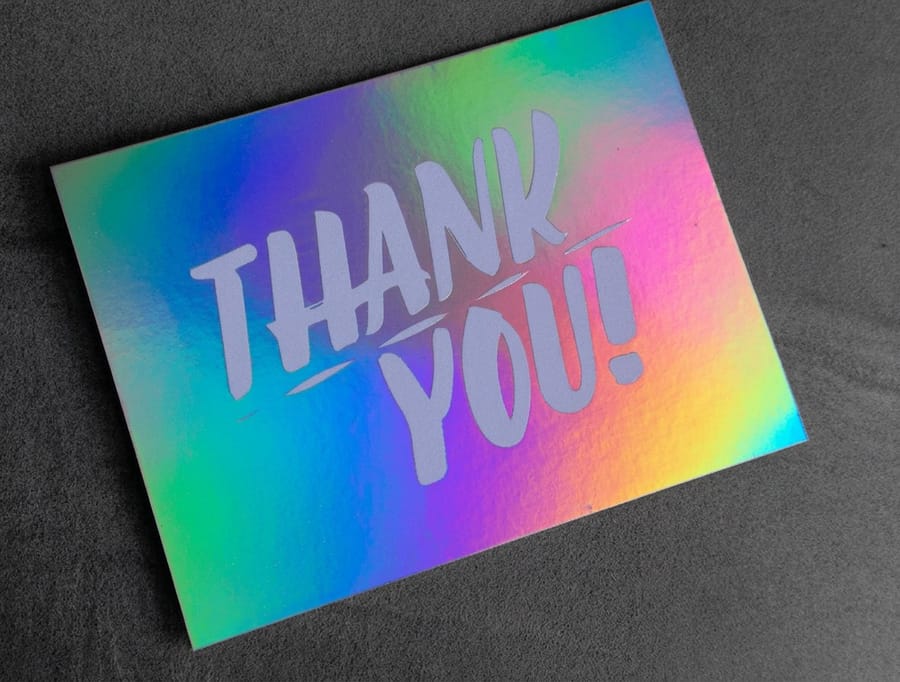 Holographic postcards printed by 4OVER4 with a full rainbow foil surface