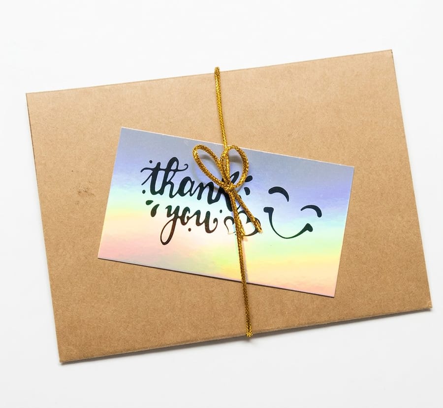 Holographic postcards printed by 4OVER4 with foil stamped detail catching the light