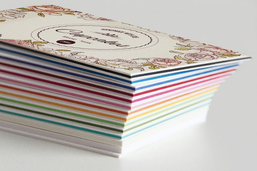 Layer Cake business cards printed by 4OVER4 with a colored core showing as a stripe along every cut edge