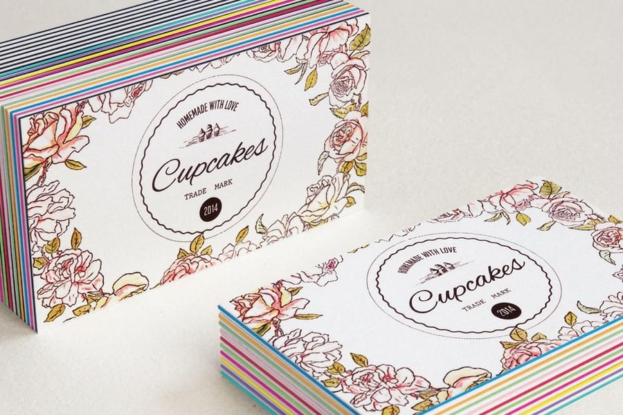 Layer Cake business cards printed by 4OVER4 held to show the colored seam between two printed faces