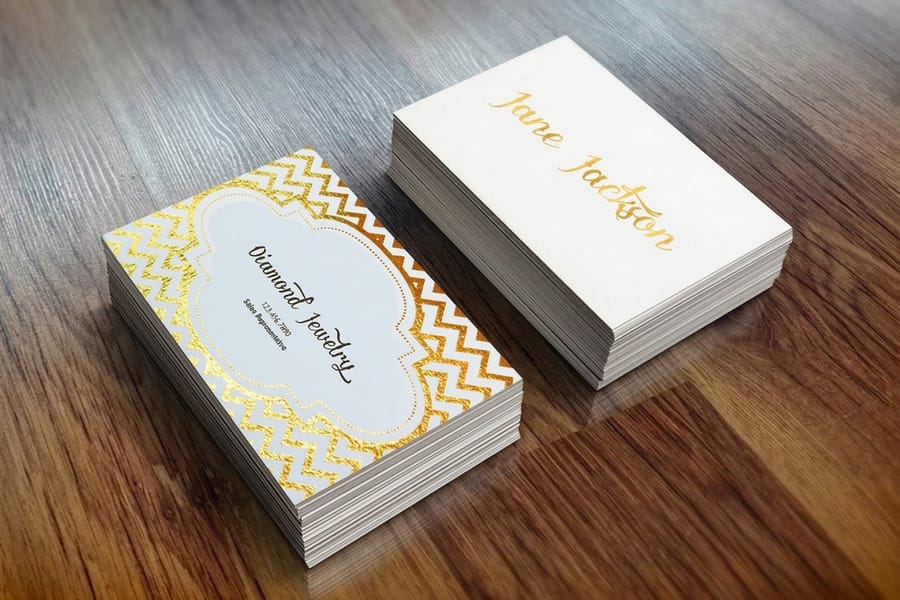 Metallic foil business card with a tagline that catches the light, printed by 4OVER4