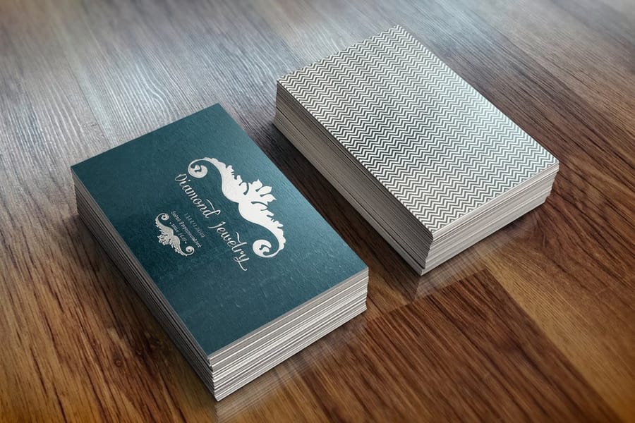 Foil business card with clean, well-placed metallic accents by 4OVER4