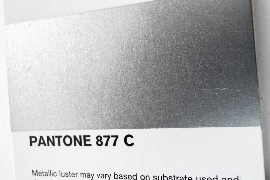 Foil stickers printed by 4OVER4 on bright silver metallic stock with printed color over the metal