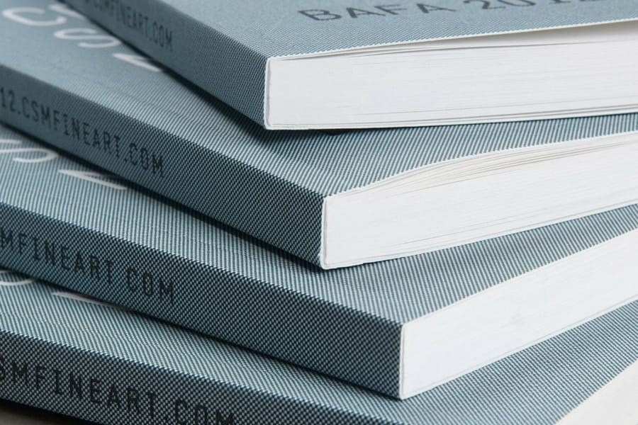 Perfect bound book standing upright on a shelf, printed by 4OVER4