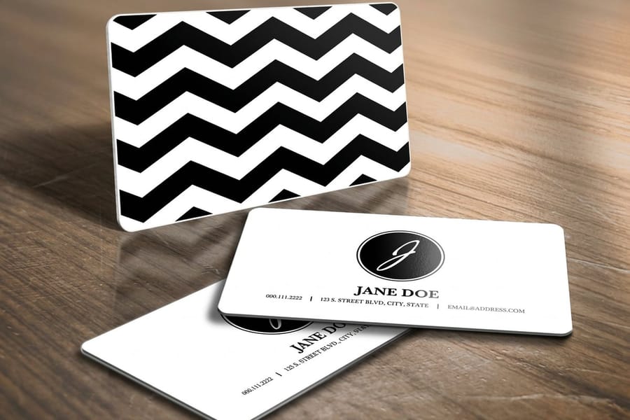 Plastic business cards printed by 4OVER4 shown as a durable wallet-sized card