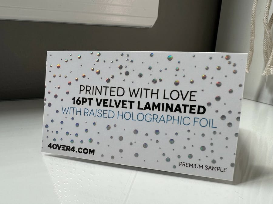 Holographic foil contrast on a dark business card background, by 4OVER4