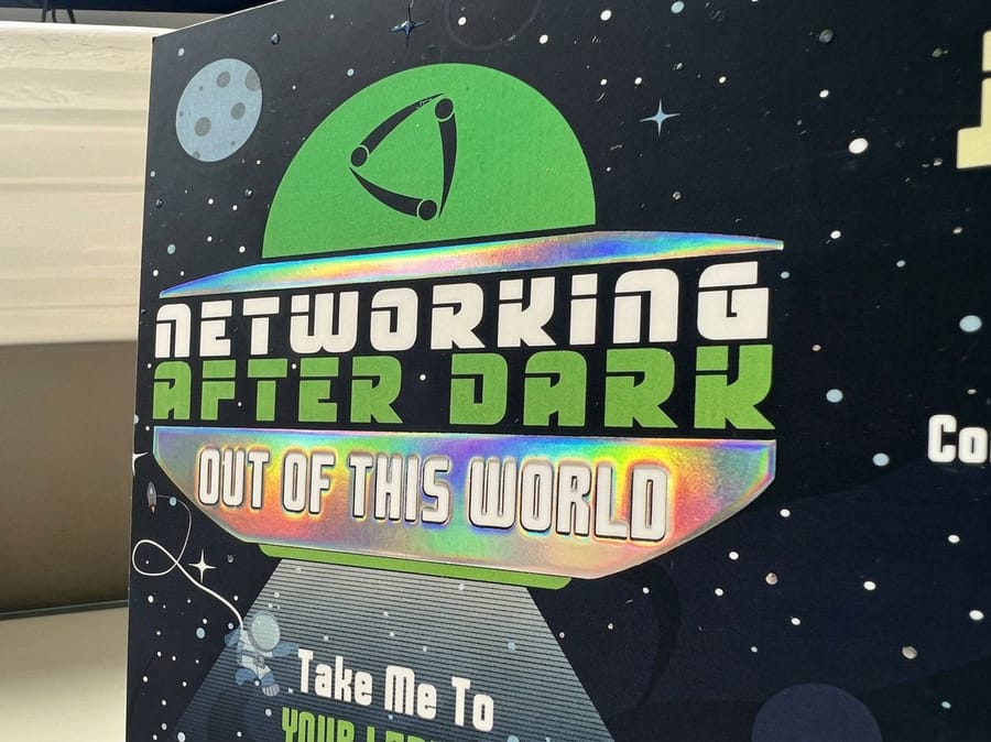 Raised holographic postcards printed by 4OVER4 with rainbow foil over a matte laminated card