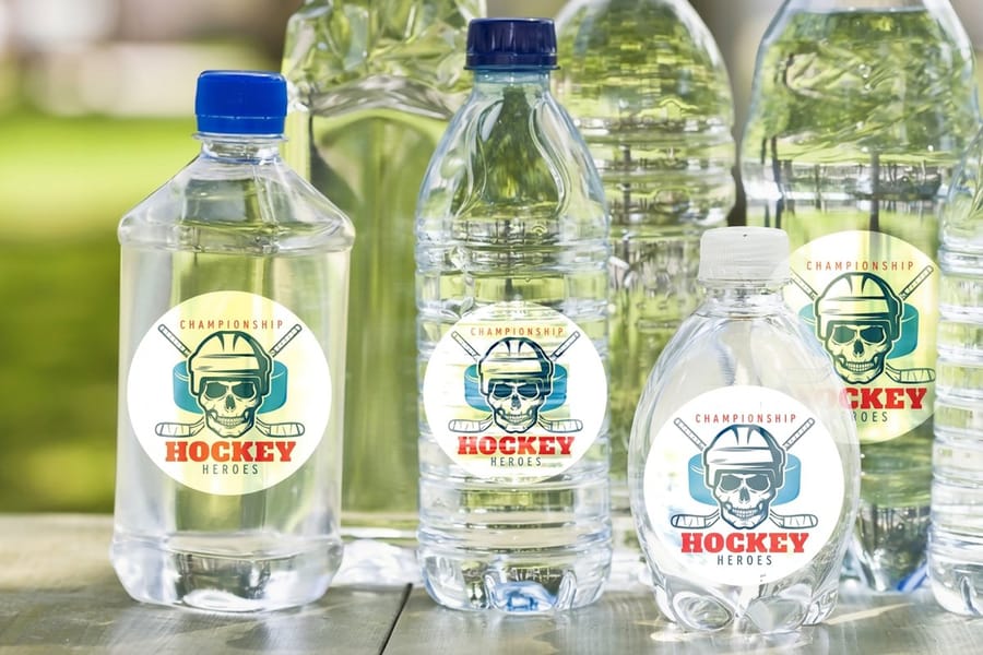 Water bottle labels printed by 4OVER4 shown flat before application, ready for artwork setup