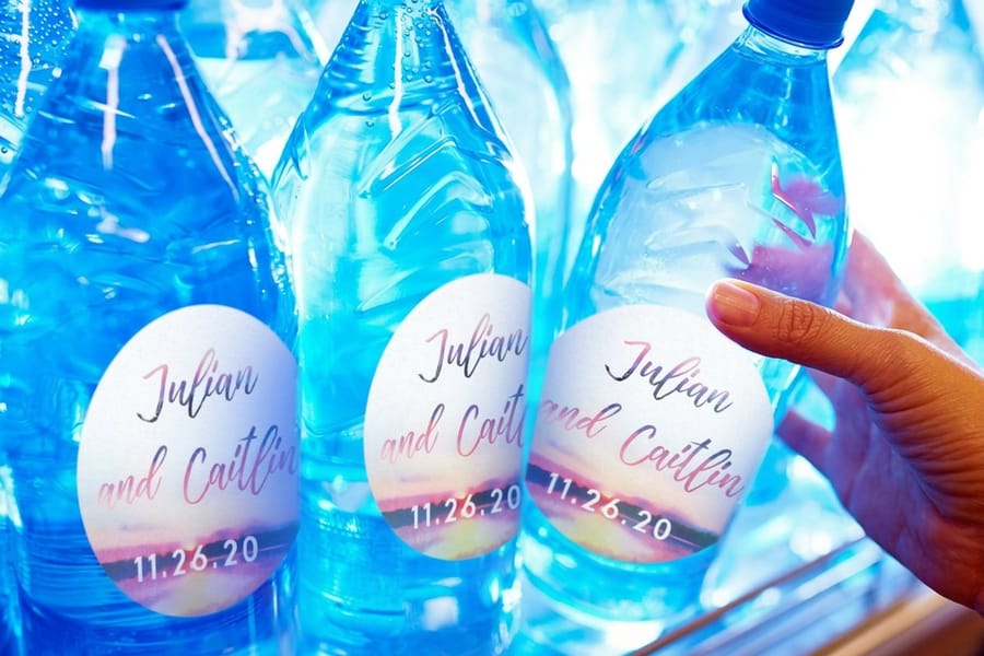 Custom water bottle labels printed by 4OVER4 wrapping bottles with a clean seam