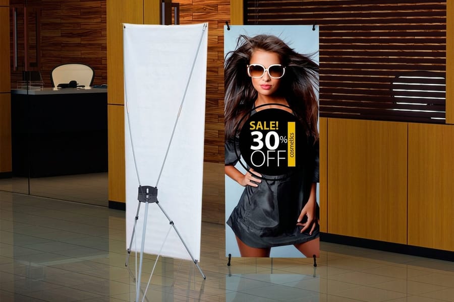 X-frame banner stand printed by 4OVER4 set up with its panel pulled taut from the corner grommets