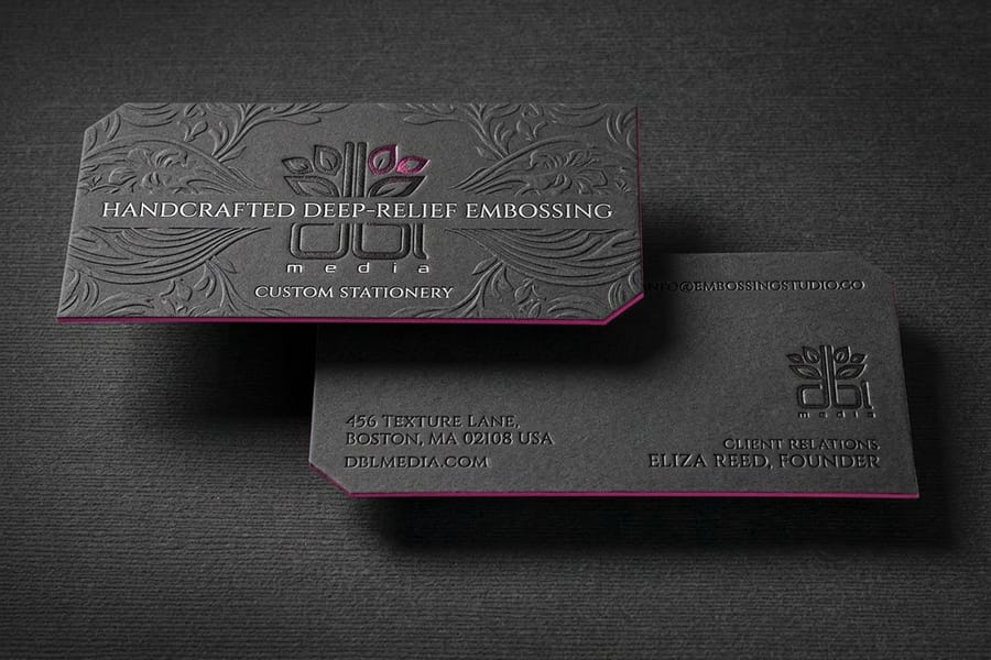 Embossed business card with a raised logo printed by 4OVER4