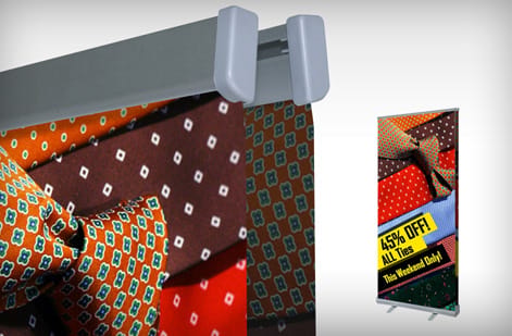 A row of retractable banner stands at different sizes, printed by 4OVER4